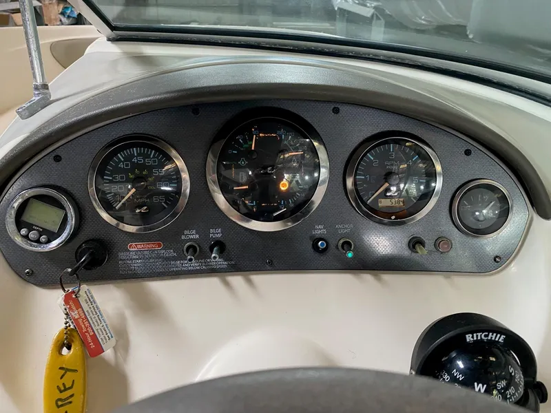 Slide: The Image of Dashboard of a 2005 Sea Ray 200 Sport boat with gauges and controls. - 9
