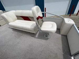 Slide: The Image of 2006 Crest Super Sport boat interior with white seating and red accents. - 10