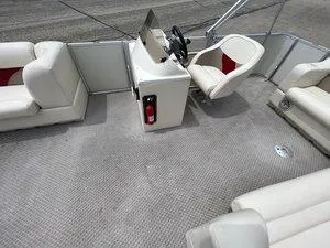 Slide: The Image of 2006 Crest Super Sport boat interior with beige seating and steering console. - 12
