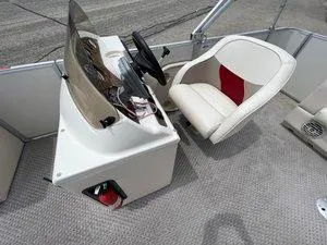 Slide: The Image of Captain's chair and helm of 2006 Crest Super Sport boat, featuring steering wheel and controls. - 13