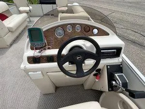 Slide: The Image of Steering console of a 2006 Crest Super Sport boat with gauges and navigation equipment. - 14