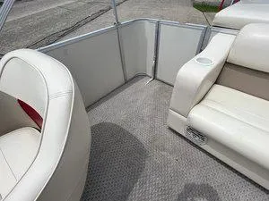 Slide: The Image of 2006 Crest Super Sport boat interior with beige seating and carpeted floor. - 15