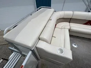 Slide: The Image of 2006 Crest Super Sport boat interior with beige seating and cup holder. - 16