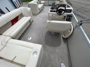Slide: The Image of 2006 Crest Super Sport boat interior with beige seating and steering console. - 19