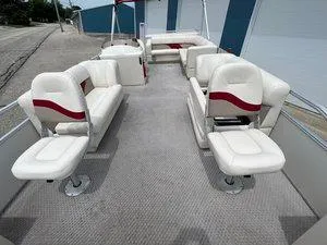Slide: The Image of 2006 Crest Super Sport boat interior with white and red seating, spacious layout. - 7