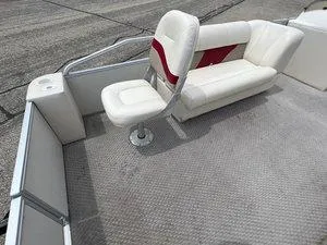 Slide: The Image of 2006 Crest Super Sport boat interior with white seating and red accents. - 9