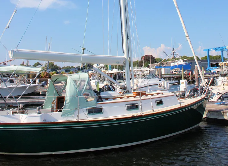 The Image of 1987 Morris Linda sailboat docked at a marina under a clear blue sky. - 0