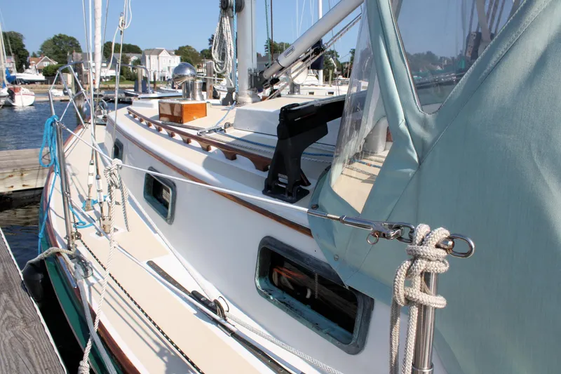 Slide: The Image of 1987 Morris Linda sailboat docked, showcasing deck details and rigging in a marina setting. - 11