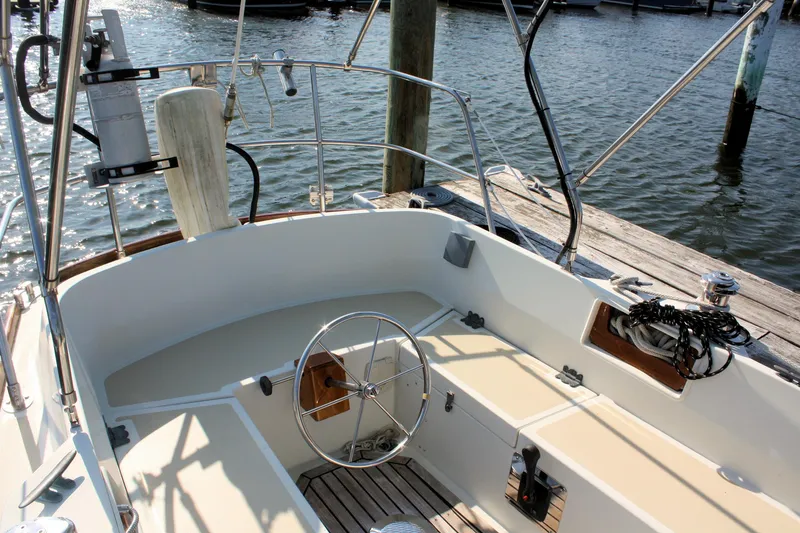 Slide: The Image of Cockpit of a 1987 Morris Linda sailboat with steering wheel and dock view. - 13