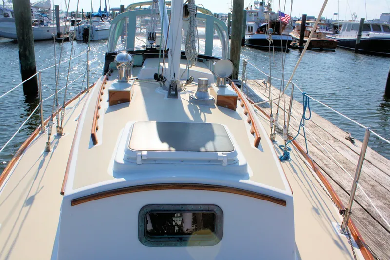Slide: The Image of 1987 Morris Linda sailboat docked at marina, showcasing deck and rigging. - 19