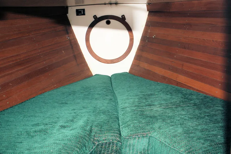 Slide: The Image of Interior cabin of 1987 Morris Linda boat with green cushions and wooden paneling. - 27