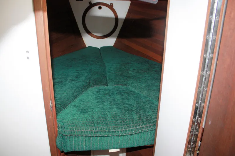 Slide: The Image of Cozy cabin interior of 1987 Morris Linda sailboat with green cushions. - 28