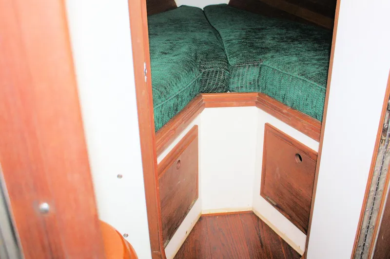 Slide: The Image of Cozy cabin interior of 1987 Morris Linda boat with green cushions and wooden accents. - 29