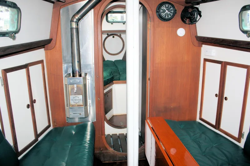 Slide: The Image of Interior of a 1987 Morris Linda boat with wood paneling and green seating. - 32