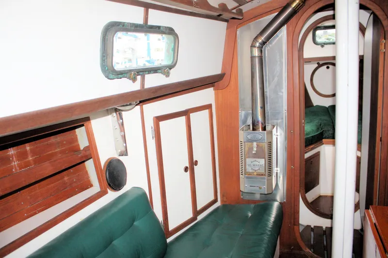 Slide: The Image of Interior of 1987 Morris Linda boat with green seating and wood paneling. - 34