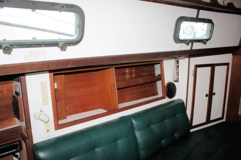 Slide: The Image of Interior of 1987 Morris Linda boat with green seating and wooden cabinetry. - 35