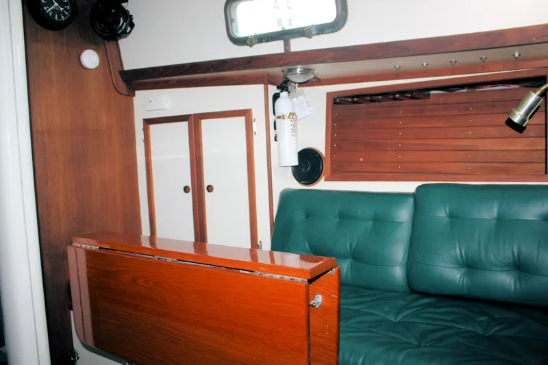Slide: The Image of Interior of a 1987 Morris Linda boat with green seating and wooden accents. - 37