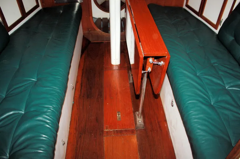 Slide: The Image of 1987 Morris Linda interior with green cushioned seating and wooden flooring. - 39
