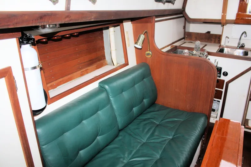 Slide: The Image of 1987 Morris Linda interior with green cushioned seating and wooden accents. - 40