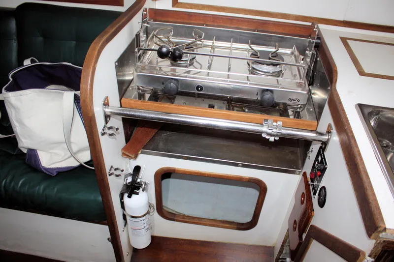Slide: The Image of Compact kitchen area in a 1987 Morris Linda boat with stove and fire extinguisher. - 42