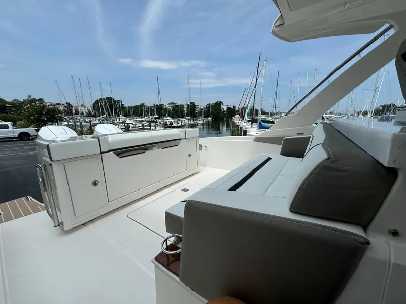 Slide: The Image of 2025 Tiara Yachts 34 LS interior with sleek seating and marina view. - 10