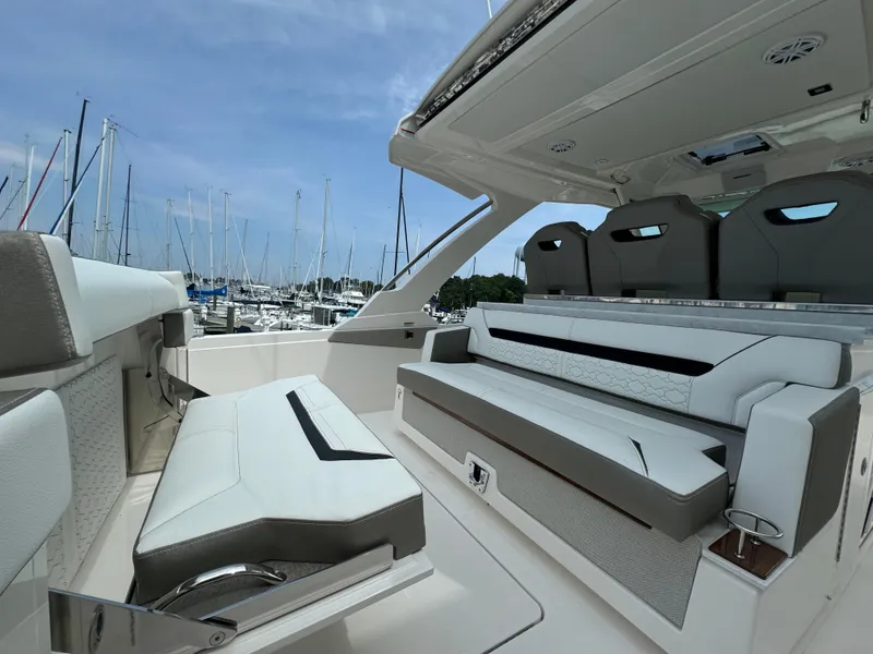 Slide: The Image of 2025 Tiara Yachts 34 LS interior with luxurious seating and marina view. - 11