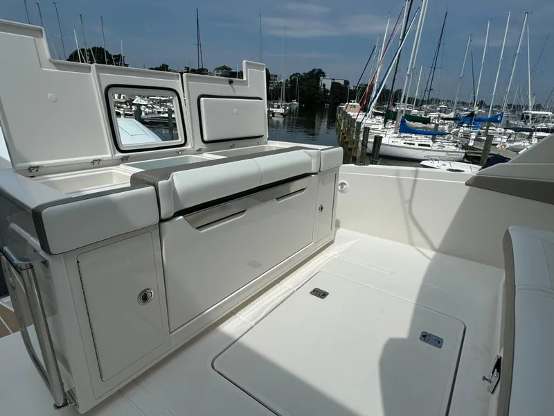 Slide: The Image of 2025 Tiara Yachts 34 LS boat interior with sleek design and marina view. - 13