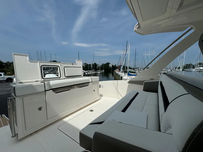 Slide: The Image of 2025 Tiara Yachts 34 LS interior with sleek seating and marina view. - 14