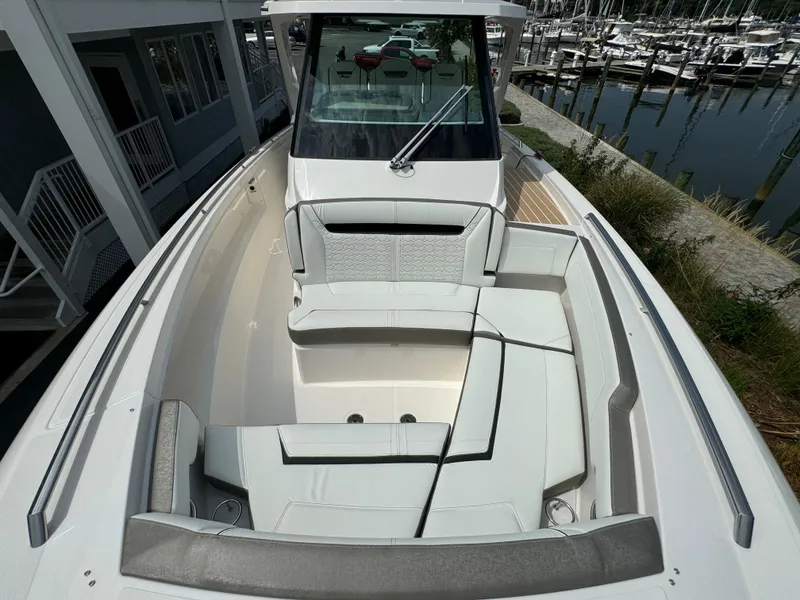 Slide: The Image of 2025 Tiara Yachts 34 LS boat with spacious seating, docked at marina. - 23
