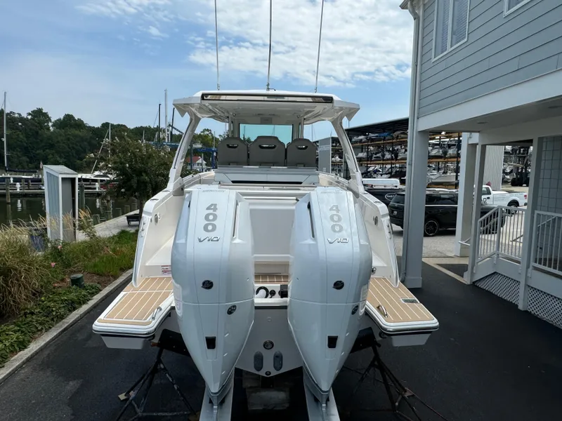 Slide: The Image of 2025 Tiara Yachts 34 LS with dual 400 V10 engines, docked at marina. - 4