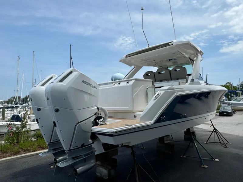 Slide: The Image of 2025 Tiara Yachts 34 LS with dual Mercury engines, docked at marina. - 5