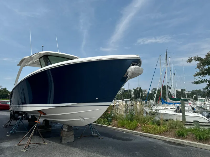 Slide: The Image of 2025 Tiara Yachts 34 LS boat on display at a marina. - 6