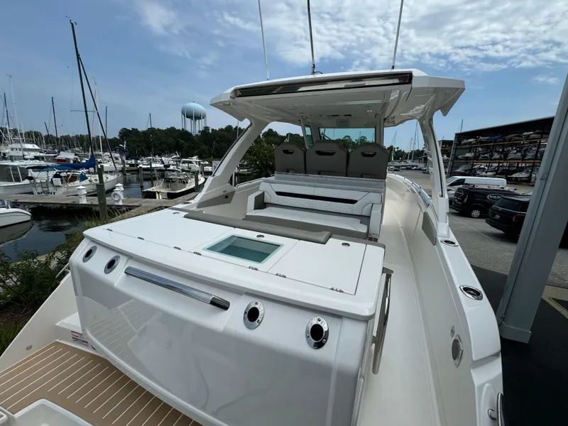 Slide: The Image of 2025 Tiara Yachts 34 LS luxury boat docked at marina under cloudy sky. - 8