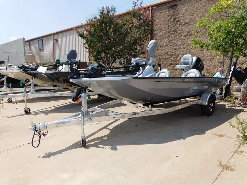 The Image of 2025 Express h17C boat on trailer, parked outdoors near building. - 0