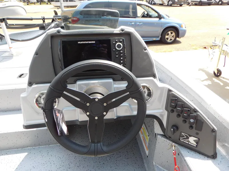Slide: The Image of Express h17C 2025 boat dashboard with steering wheel and navigation controls. - 8