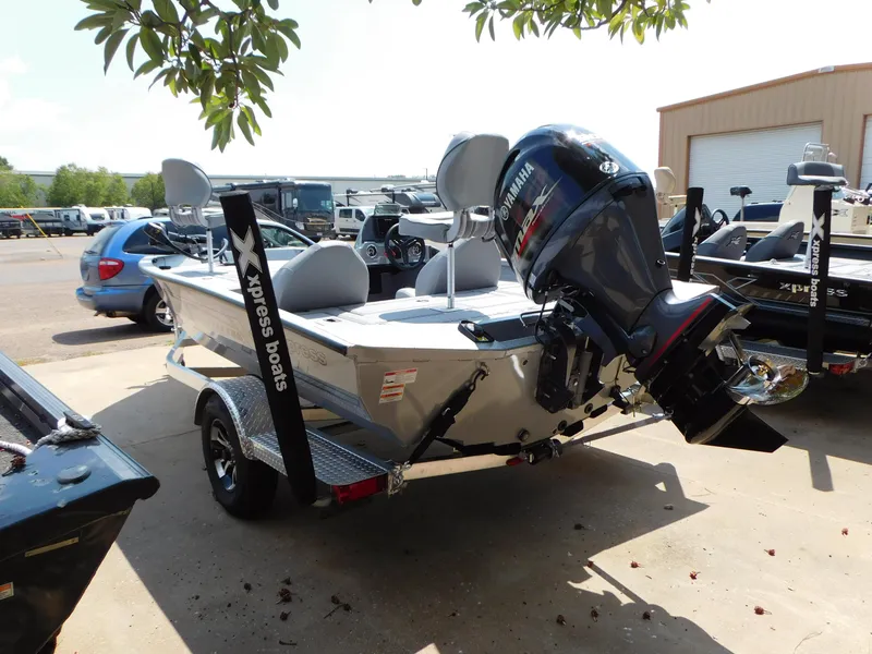 Slide: The Image of 2025 Express h17C boat with Yamaha outboard motor on trailer, parked outdoors. - 9