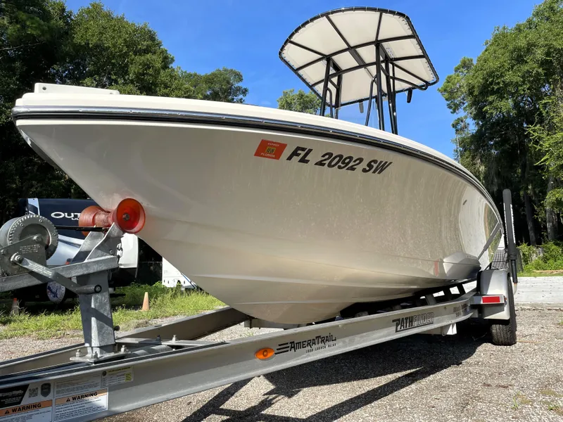 Slide: The Image of Pathfinder 2005 TRS boat on trailer, side view, sunny day, trees in background. - 10