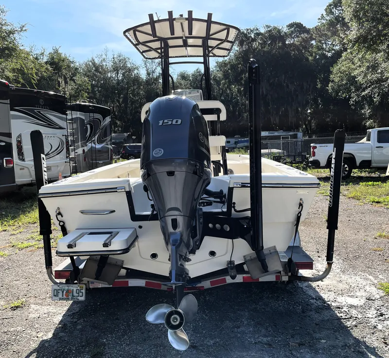 Slide: The Image of Pathfinder 2005 TRS boat with 150 HP engine, parked outdoors, 2021 model. - 12