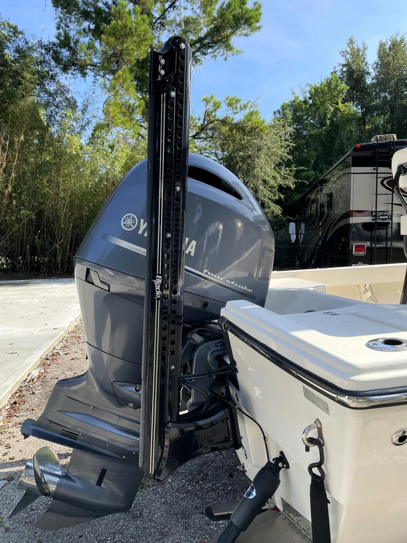 Slide: The Image of Pathfinder 2005 TRS boat with Yamaha outboard motor, parked outdoors, 2021 model. - 18