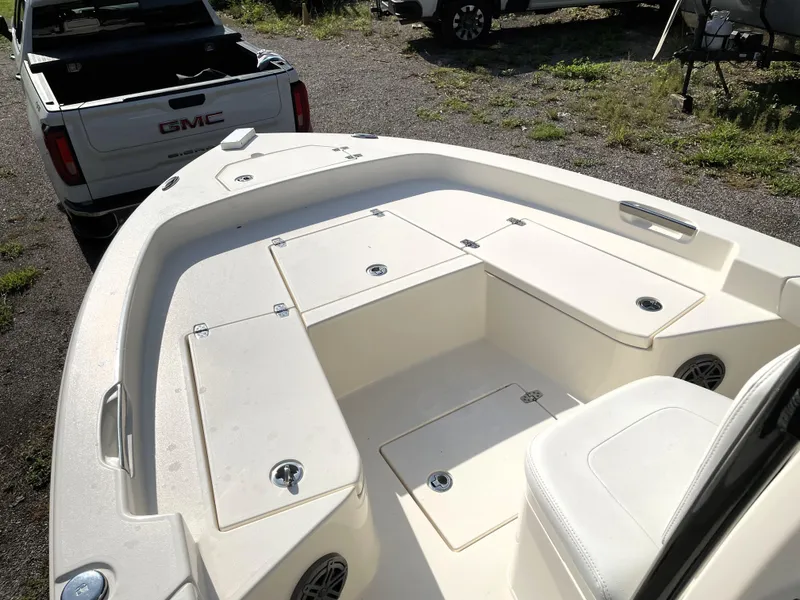 Slide: The Image of Pathfinder 2005 TRS boat interior, 2021 model, with storage compartments and seating, parked near a GMC truck. - 22