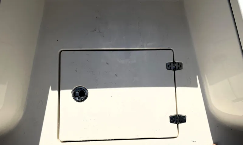 Slide: The Image of Storage compartment on a 2021 Pathfinder 2005 TRS boat, featuring a secure latch. - 28