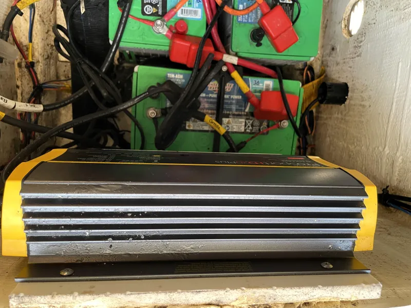 Slide: The Image of Battery charger and wiring setup in a 2021 Pathfinder 2005 TRS boat. - 34