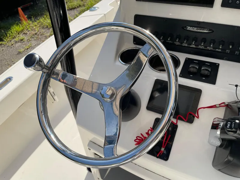 Slide: The Image of Steering wheel of a 2021 Pathfinder 2005 TRS boat with control panel. - 40