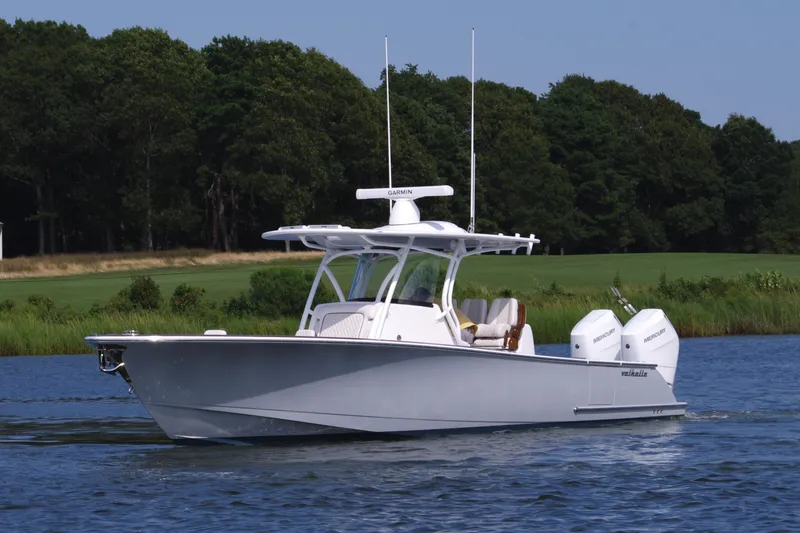 Slide: The Image of 2025 Valhalla Boatworks V-33 cruising on a serene lake with lush greenery. - 11