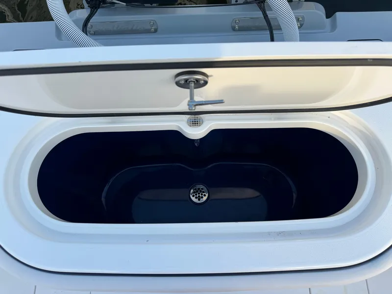 Slide: The Image of 2025 Valhalla Boatworks V-33 livewell with open lid, showcasing interior design. - 17