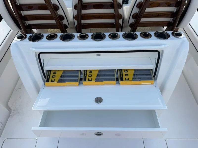 Slide: The Image of Valhalla Boatworks V-33 2025 fishing tackle storage with rod holders and organized compartments. - 24