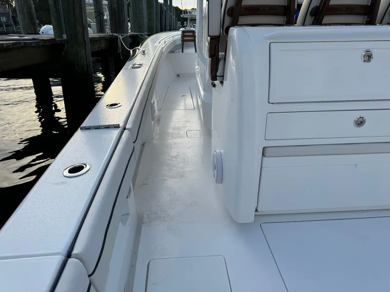 Slide: The Image of 2025 Valhalla Boatworks V-33 interior, showcasing sleek white deck and storage compartments. - 26