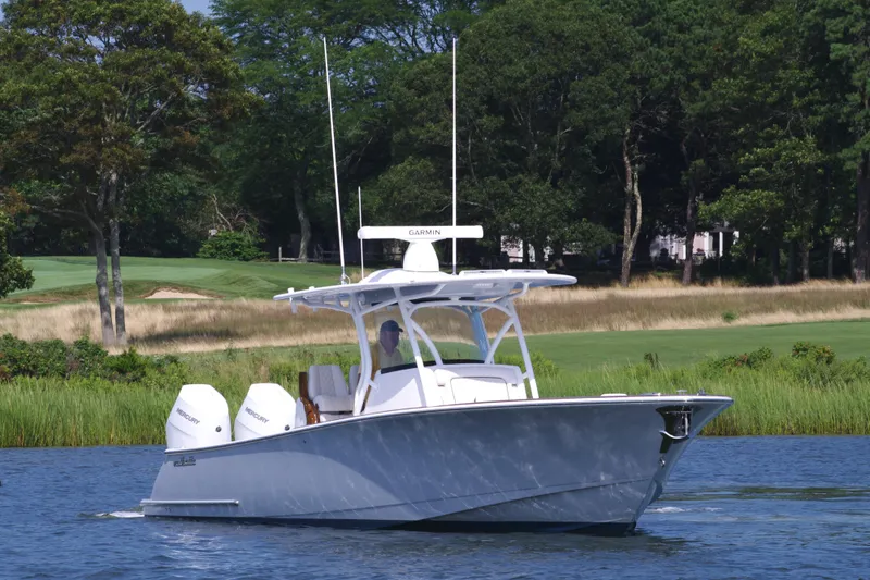 Slide: The Image of 2025 Valhalla Boatworks V-33 cruising on a serene lake with lush greenery. - 3