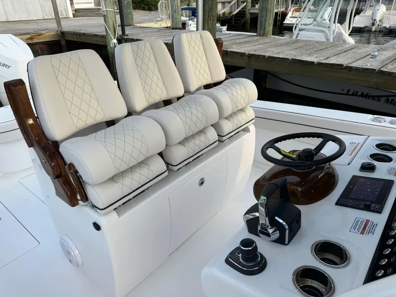 Slide: The Image of Luxurious seating and helm of 2025 Valhalla Boatworks V-33, featuring modern controls. - 30