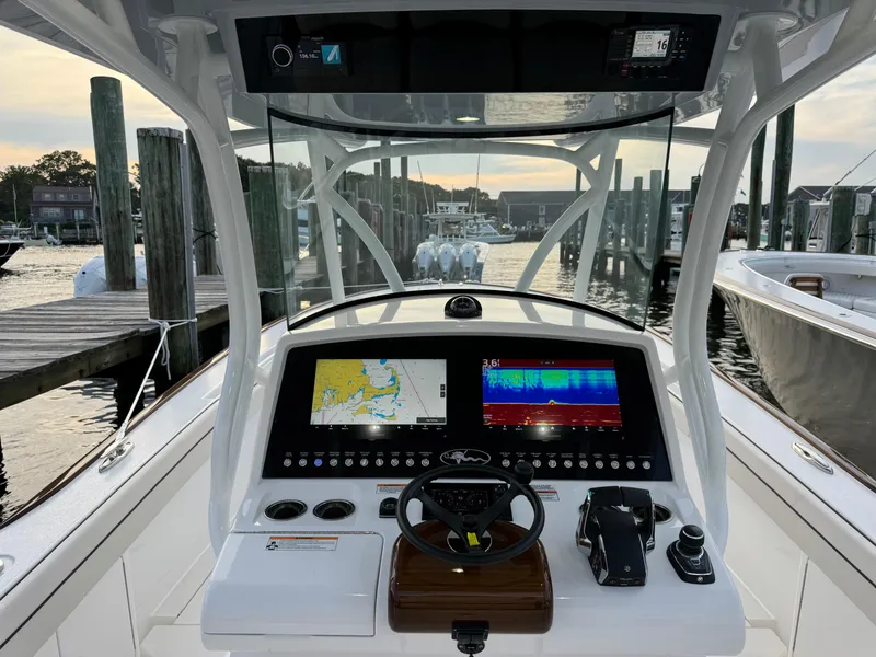 Slide: The Image of 2025 Valhalla Boatworks V-33 helm with advanced navigation system at marina. - 33